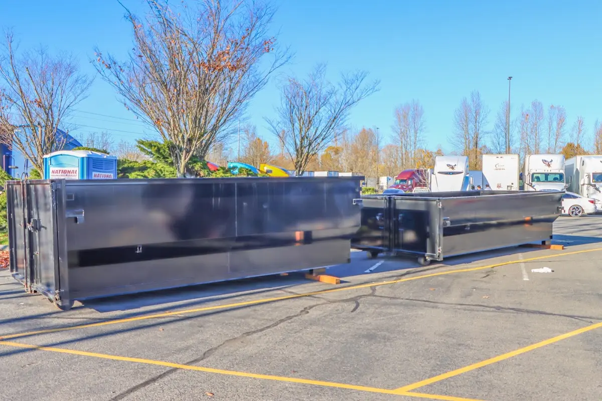 Professional dumpster rental service with roll-off container on residential driveway in Chelmsford